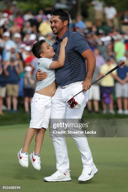 Jason Day of Australia celebrates with his son Dash on the 18th green during the final round after winning the 2018 Wells Fargo Championship at Quail...