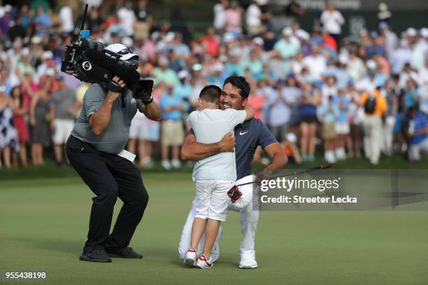 Jason Day of Australia celebrates with his son Dash on the 18th green during the final round after winning the 2018 Wells Fargo Championship at Quail...