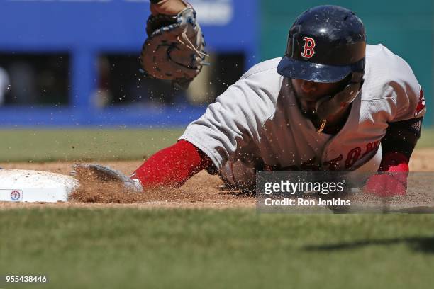 Eduardo Nunez of the Boston Red Sox dives safely back to first base avoiding the tag by Ronald Guzman of the Texas Rangers during the sixth inning at...