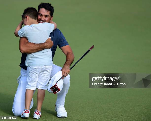 Jason Day of Australia celebrates with his son Dash on the 18th green during the final round after winning the 2018 Wells Fargo Championship at Quail...