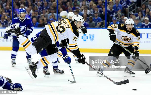 Charlie McAvoy of the Boston Bruins jumps over Ryan McDonagh of the Tampa Bay Lightning during Game Five of the Eastern Conference Second Round...