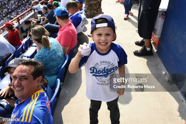 Young fan poses for a photo during the game between the Los Angeles Dodgers and the San Diego Padres at Estadio de Béisbol Monterrey on Sunday, May...