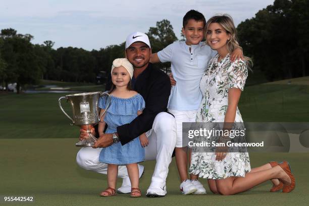 Jason Day of Australia and his wife Ellie pose with their children, Dash and Lucy, on the 18th green after winning the 2018 Wells Fargo Championship...