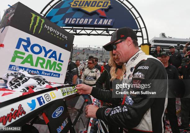 Kevin Harvick, driver of the Jimmy John's Ford, poses with the winner's sticker after winning the Monster Energy NASCAR Cup Series AAA 400 Drive for...