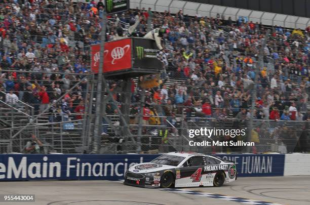 Kevin Harvick, driver of the Jimmy John's Ford, takes the checkered flag to win the Monster Energy NASCAR Cup Series AAA 400 Drive for Autism at...