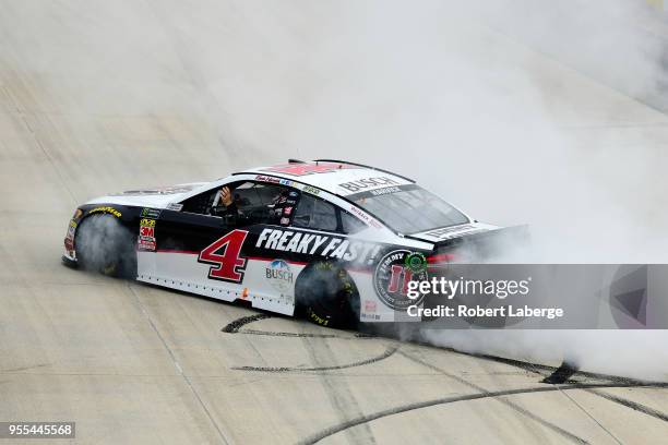 Kevin Harvick, driver of the Jimmy John's Ford, celebrates with a burnout after winning the Monster Energy NASCAR Cup Series AAA 400 Drive for Autism...