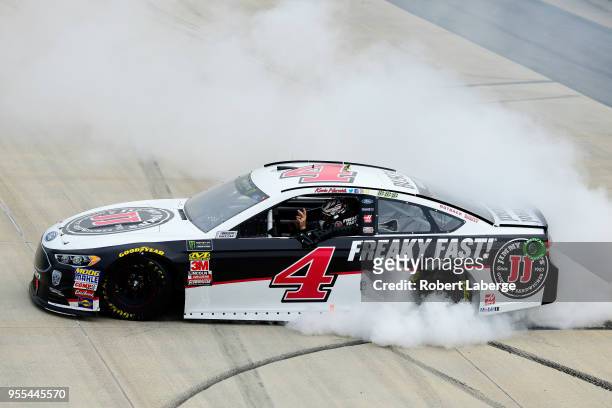 Kevin Harvick, driver of the Jimmy John's Ford, celebrates with a burnout after winning the Monster Energy NASCAR Cup Series AAA 400 Drive for Autism...