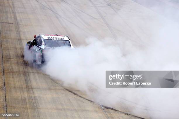 Kevin Harvick, driver of the Jimmy John's Ford, celebrates with a burnout after winning the Monster Energy NASCAR Cup Series AAA 400 Drive for Autism...