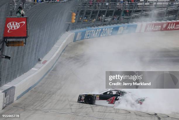 Kevin Harvick, driver of the Jimmy John's Ford, celebrates with a burnout after winning the Monster Energy NASCAR Cup Series AAA 400 Drive for Autism...