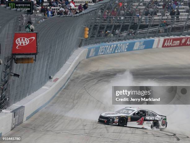 Kevin Harvick, driver of the Jimmy John's Ford, celebrates with a burnout after winning the Monster Energy NASCAR Cup Series AAA 400 Drive for Autism...