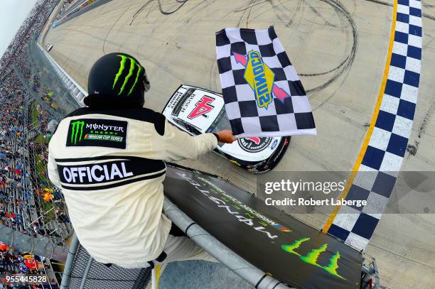 Kevin Harvick, driver of the Jimmy John's Ford, takes the checkered flag to win the Monster Energy NASCAR Cup Series AAA 400 Drive for Autism at...