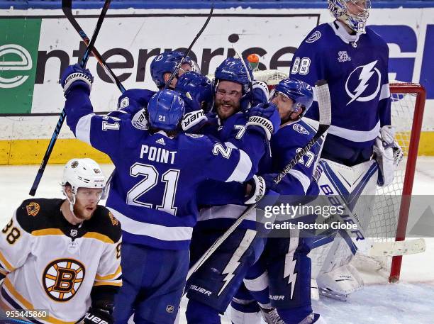 Boston Bruins right wing David Pastrnak skates away from the Tampa Bay Lightning celebration after Tampa scored an empty net goal to seal the 3-1 win...