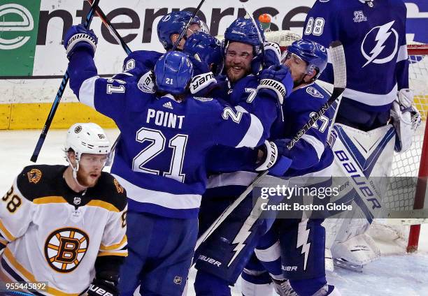 Boston Bruins right wing David Pastrnak skates away from the Tampa Bay Lightning celebration after Tampa scored an empty net goal to seal the 3-1 win...