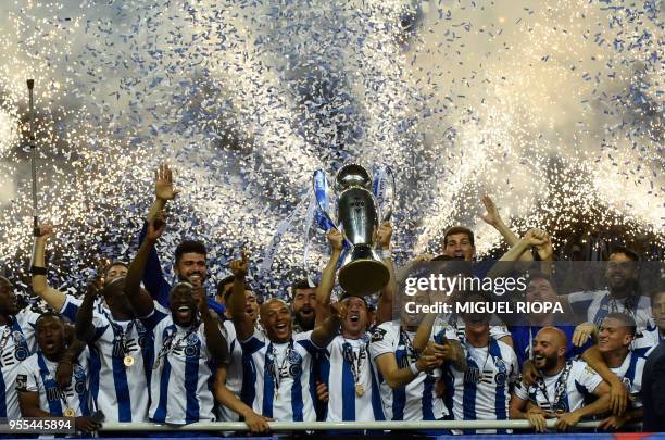 Porto's players celebrate with the trophy after winning the league title following the Portuguese league football match between FC Porto and CD...
