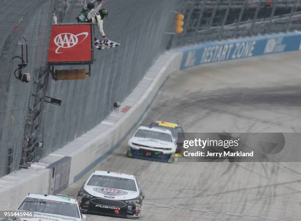 Kevin Harvick, driver of the Jimmy John's Ford, takes the checkered flag to win the Monster Energy NASCAR Cup Series AAA 400 Drive for Autism at...