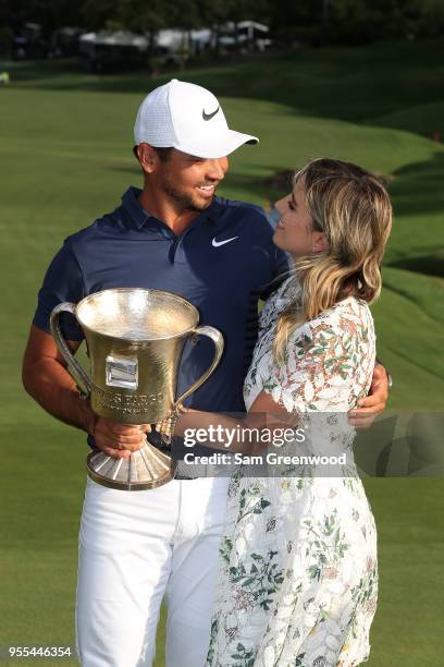 Jason Day of Australia and his wife Ellie pose with the trophy on the 18th green after winning the 2018 Wells Fargo Championship at Quail Hollow Club...