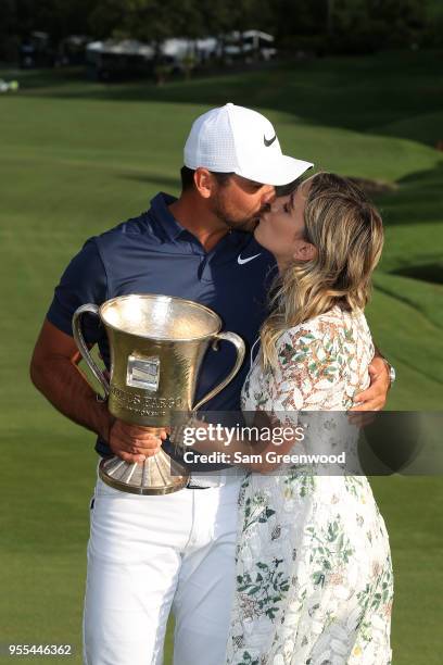 Jason Day of Australia and his wife Ellie pose with the trophy on the 18th green after winning the 2018 Wells Fargo Championship at Quail Hollow Club...