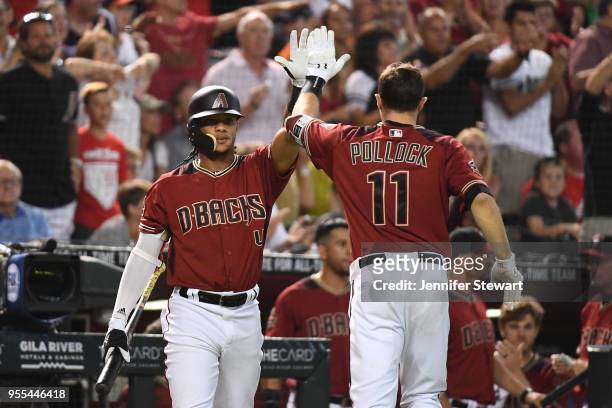 Pollock of the Arizona Diamondbacks is congratulated by Ketel Marte after scoring against the Houston Astros in the sixth inning of the MLB game at...