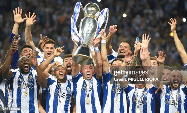 Porto's players celebrate with the trophy after winning the league title following the Portuguese league football match between FC Porto and CD...