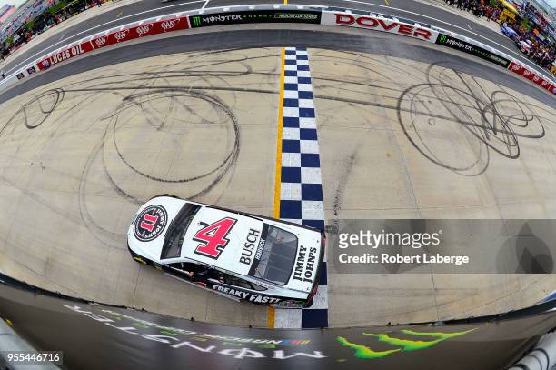 Kevin Harvick, driver of the Jimmy John's Ford, celebrates after a burnout after winning the Monster Energy NASCAR Cup Series AAA 400 Drive for...