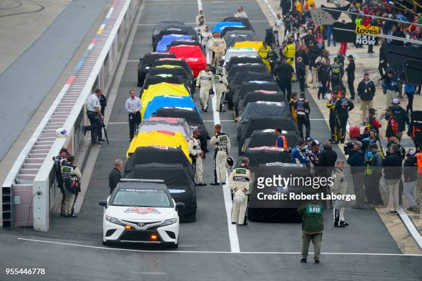 The field sits on pit road during a rain delay in the Monster Energy NASCAR Cup Series AAA 400 Drive for Autism at Dover International Speedway on...