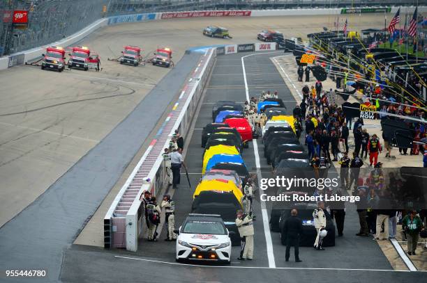 The field sits on pit road during a rain delay in the Monster Energy NASCAR Cup Series AAA 400 Drive for Autism at Dover International Speedway on...