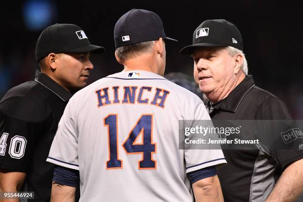 Hinch of the Houston Astros talks with umpires Roberto Ortiz and Brian Gorman during the sixth inning of the MLB game against the Arizona...
