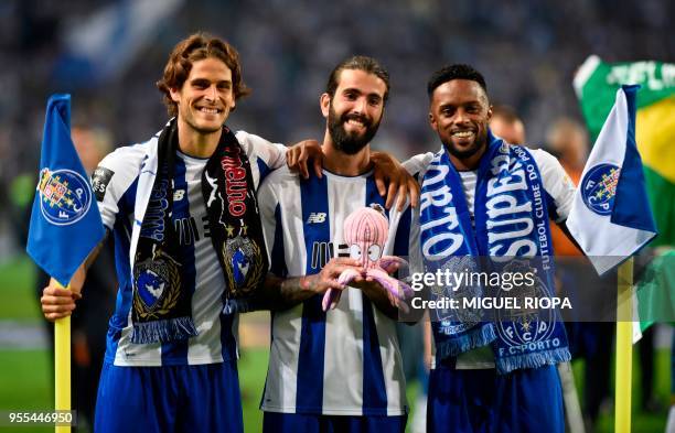 Porto's Portuguese forward Goncalo Paciencia, Portuguese midfielder Sergio Oliveira and Portuguese forward Hernani celebrate after winning the league...