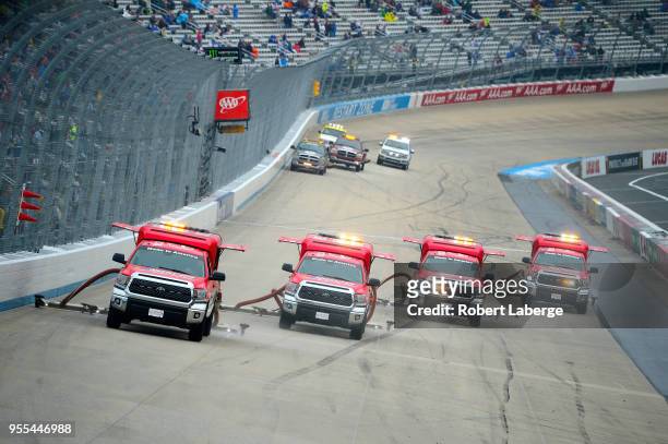 Dryers attend to the track during a rain delay in the Monster Energy NASCAR Cup Series AAA 400 Drive for Autism at Dover International Speedway on...