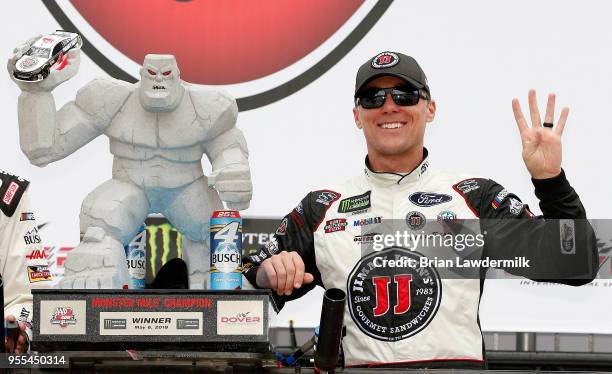 Kevin Harvick, driver of the Jimmy John's Ford, poses with the trophy after winning the Monster Energy NASCAR Cup Series AAA 400 Drive for Autism at...