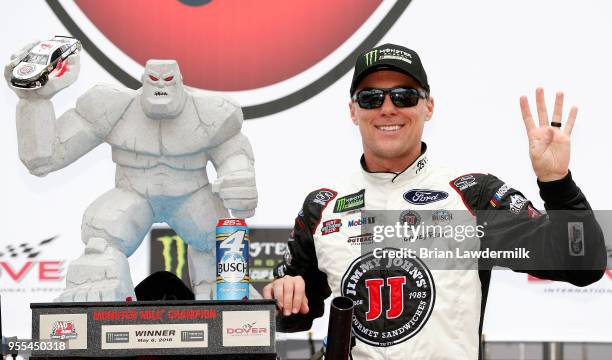 Kevin Harvick, driver of the Jimmy John's Ford, poses with the trophy after winning the Monster Energy NASCAR Cup Series AAA 400 Drive for Autism at...