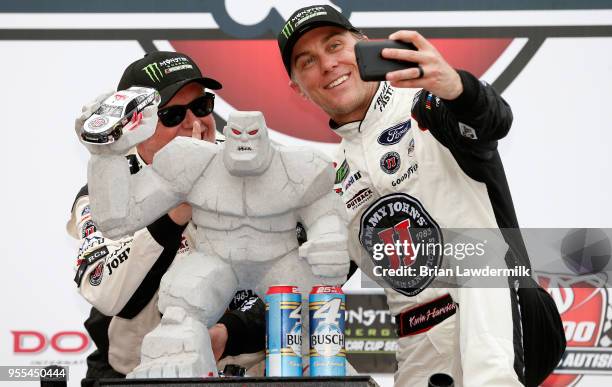 Kevin Harvick, driver of the Jimmy John's Ford, takes a "selfie" with a crew member after winning the Monster Energy NASCAR Cup Series AAA 400 Drive...