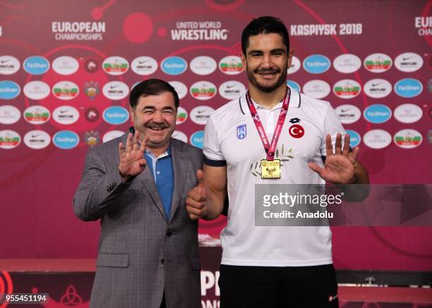 Turkish wrestler Taha Akgul poses for a photo with Musa Aydin , President of the Turkish Wrestling Federation during a medal ceremony after he won...