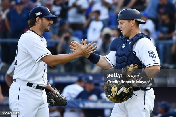 Brad Hand and A.J. Ellis of the San Diego Padres celebrate after the Padres defeated the Los Angeles Dodgers at Estadio de Béisbol Monterrey on...