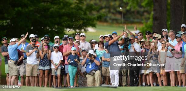 Golfer Jason Day watches the flight of his drive with the gallery after hitting from the rough along the seventh fairway during fourth round action...