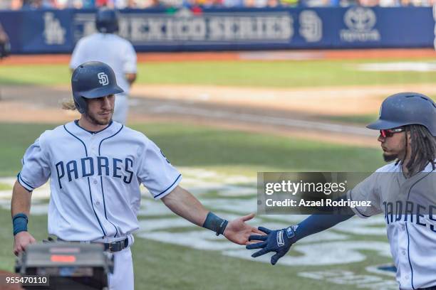 Center fielder Travis Jankowski of San Diego Padres celebrates with shortstop Freddy Galvis after getting home in the seventh inning during the MLB...