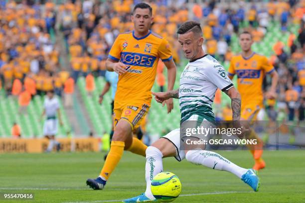 Santos' player Brian Lozano vies for the ball with Tigres' Israel Jimenez during their Mexican Clausura tournament second leg quarterfinal football...
