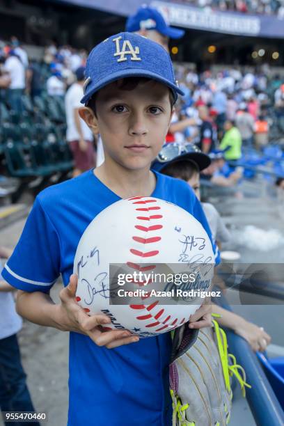 Boy holds a giant signed ball during the MLB game between the San Diego Padres and the Los Angeles Dodgers at Estadio de Beisbol Monterrey on May 6,...