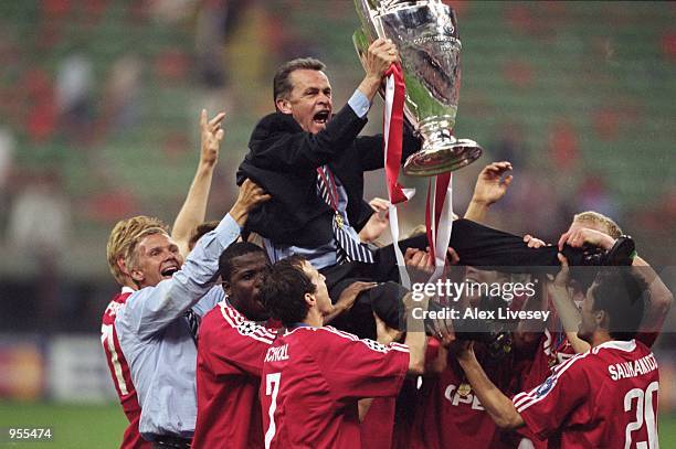 Bayern Munich Coach Ottmar Hitzfeld is held aloft by his players after the Uefa Champions League Final between Bayern Munich and Valencia played at...