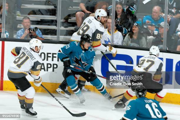 Marcus Sorensen of the San Jose Sharks battles with Jonathan Marchessault, Alex Tuch and Shea Theodore of the Vegas Golden Knights for the puck in...
