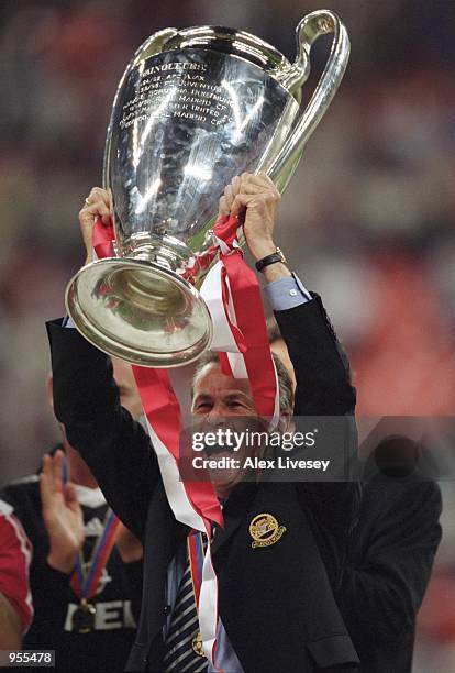 Bayern Munich Coach Ottmar Hitzfeld lifts the trophy after the Uefa Champions League Final between Bayern Munich and Valencia played at the San Siro...