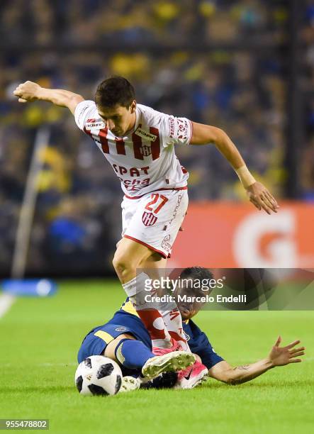 Julio Buffarini of Boca Juniors fights for the ball with Franco Soldano of Union during a match between Boca Juniors and Union de Santa Fe as part of...