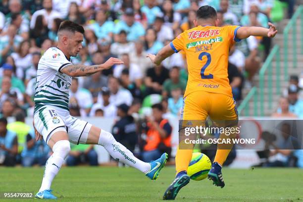 Santos' player Brian Lozano vies for the ball with Tigres' Israel Jimenez during their Mexican Clausura tournament second leg quarterfinal football...