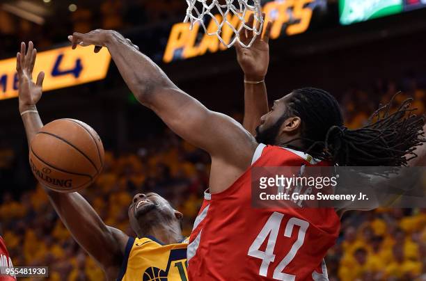 Alec Burks of the Utah Jazz loses the ball while trying for the basket past the defense of Nene Hilario of the Houston Rockets in the first half...