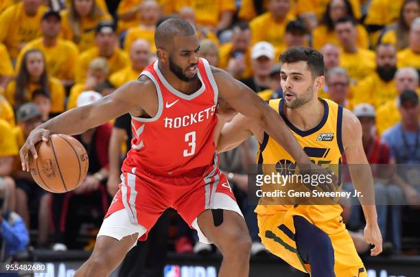 Chris Paul of the Houston Rockets controls the ball in front of Raul Neto of the Utah Jazz in the first half during Game Four of Round Two of the...