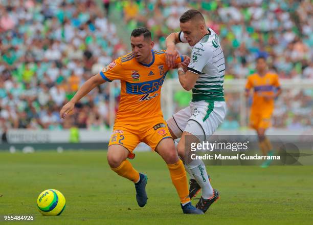 Israel Jimenez of Tigres and Jonathan Rodriguez of Santos fight for the ball during the quarter finals second leg match between Santos Laguna and...