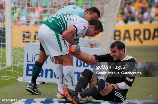 Nahuel Guzman of Tigres lies on the ground after being injured during the quarter finals second leg match between Santos Laguna and Tigres UANL as...