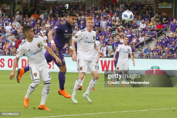 Dom Dwyer of Orlando City SC heads the ball into the net past Adam Henley of Real Salt Lake and Justen Glad of Real Salt Lake during a MLS soccer...