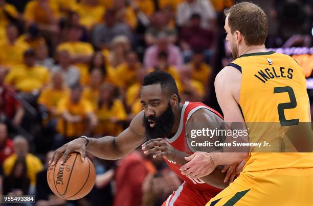 James Harden of the Houston Rockets tries to drive around Joe Ingles of the Utah Jazz in the second half during Game Four of Round Two of the 2018...