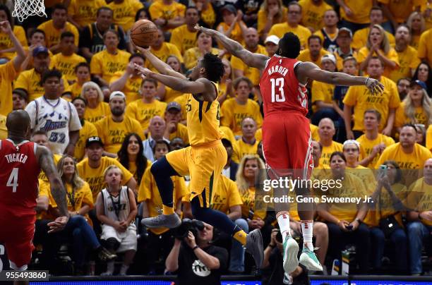 Donovan Mitchell of the Utah Jazz goes to the basket under the defense of James Harden of the Houston Rockets in the second half during Game Four of...